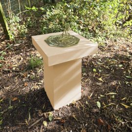 Contemporary Sundial in garden corner buff